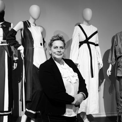 Author Deborah Levy in front of mannequins at the Manchester Art Gallery exhibition Fashion and Freedom in 2016